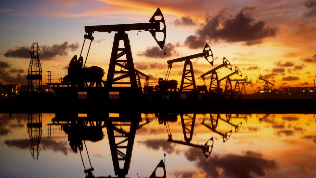 107065218 1653293244892 gettyimages 1323151704 oil pumps and rig at sunset